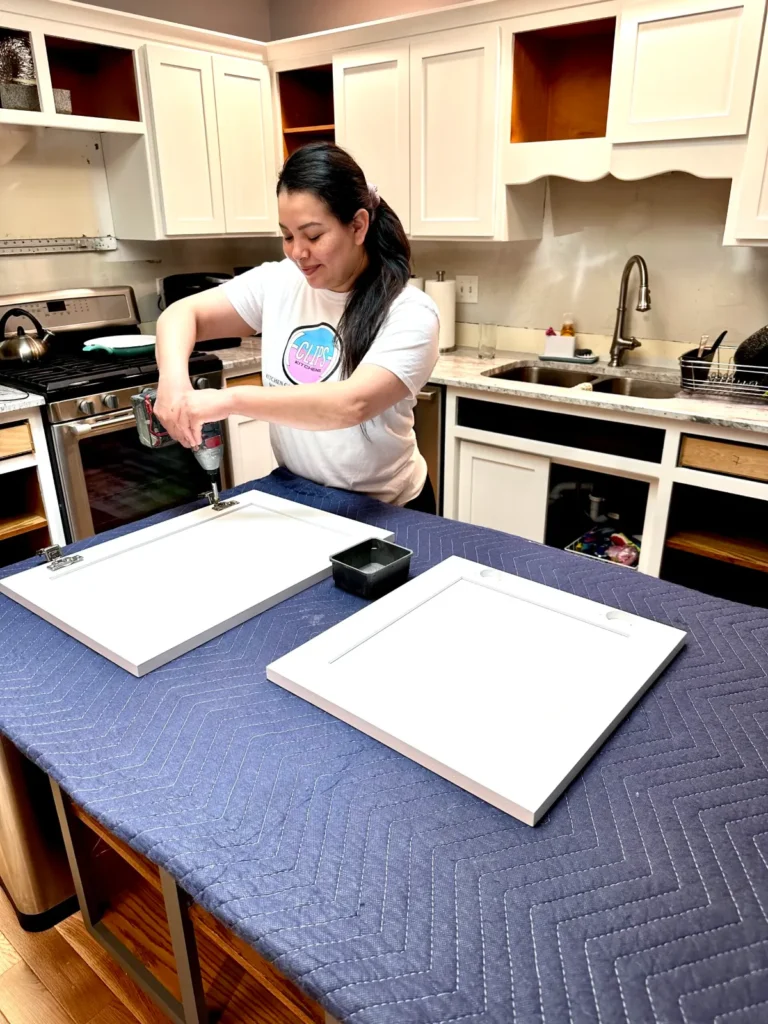 Eclips3 technician installing new hardware on refaced cabinet doors