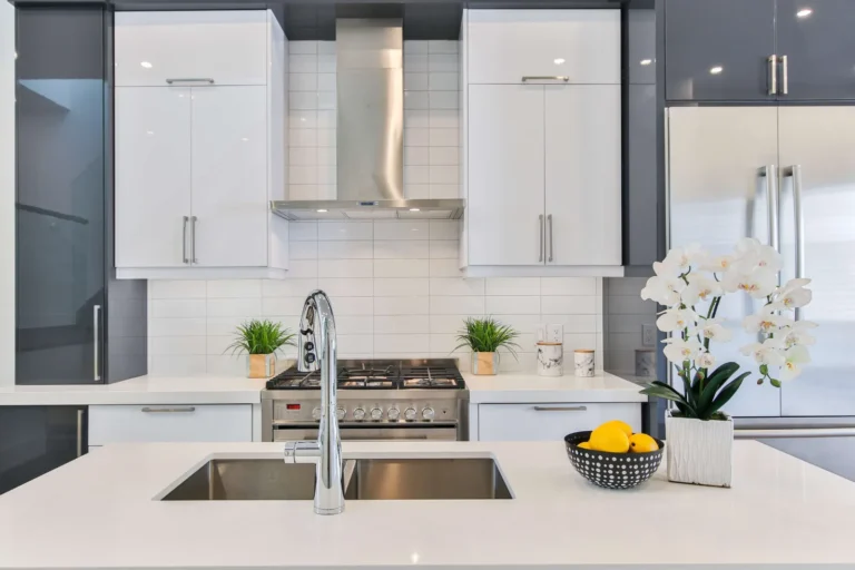 Modern white kitchen cabinets with a stainless steel range hood
