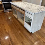 Kitchen island cabinets being modified and prepped for paint