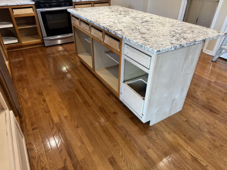 Kitchen island cabinets being modified and prepped for paint