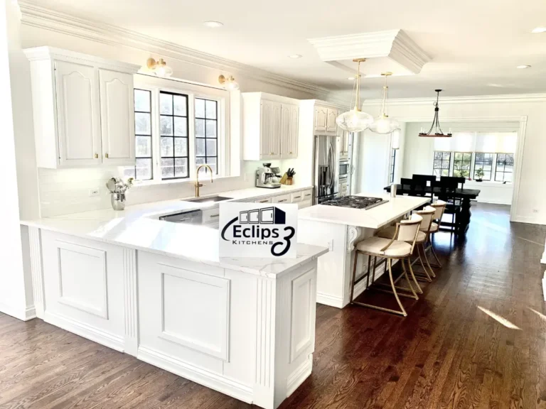 White painted kitchen with a large island and bar stools