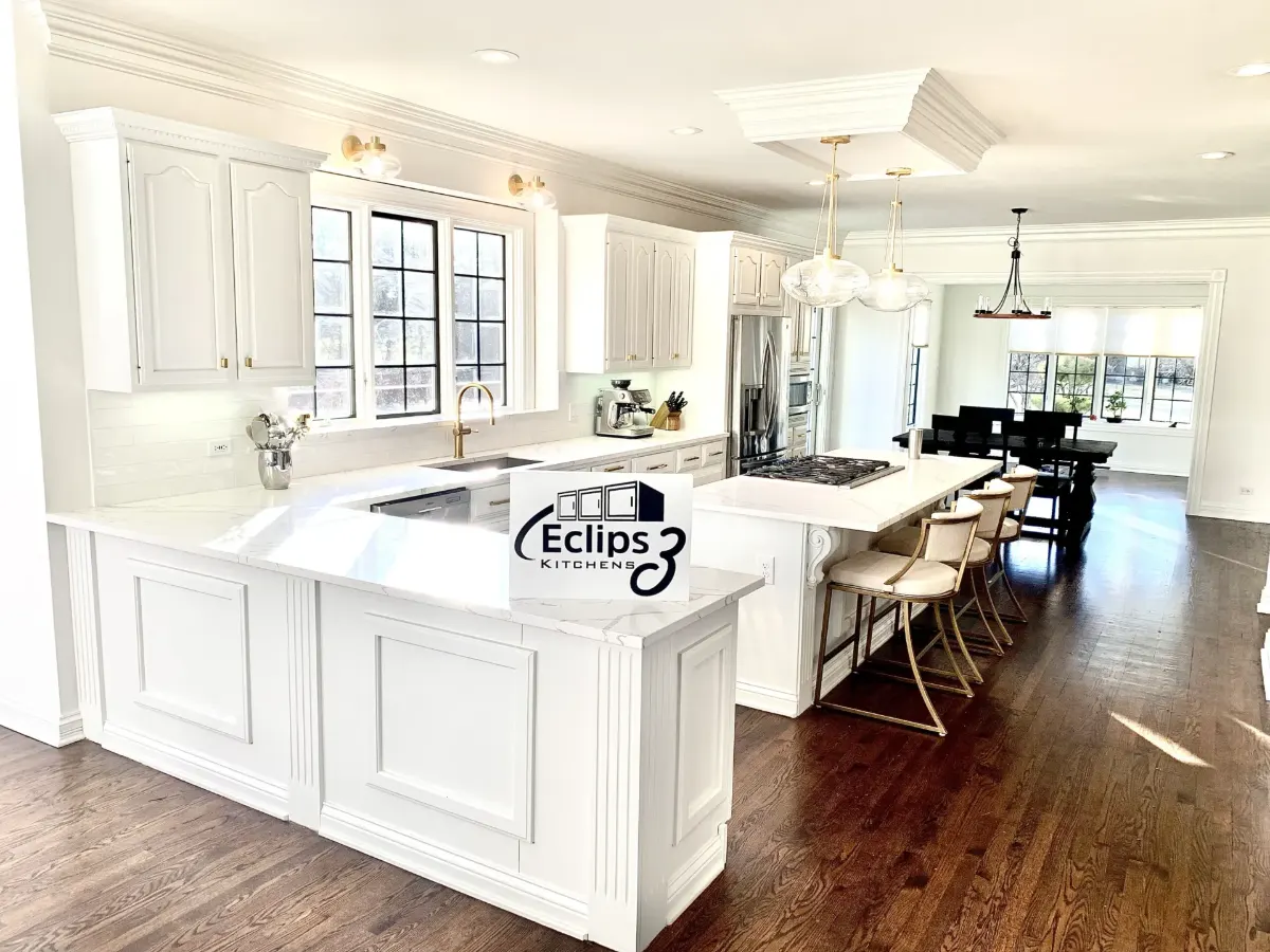 White painted kitchen with a large island and bar stools