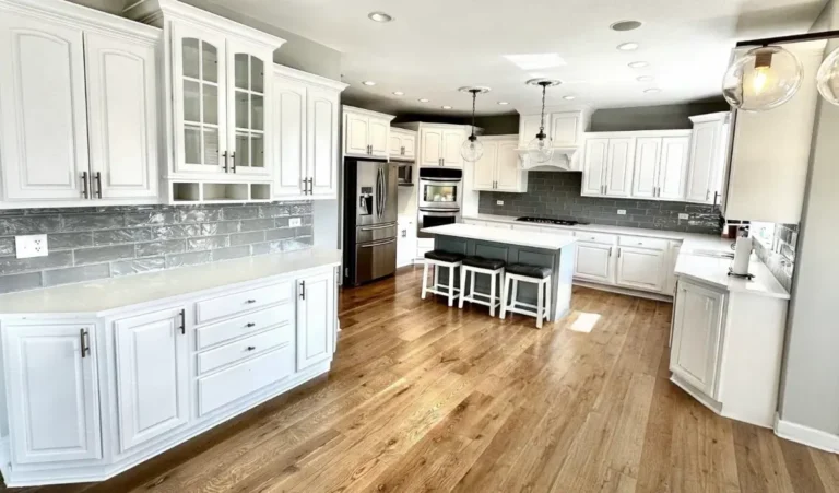 White painted kitchen cabinets and a gray island in a Western Springs, IL home